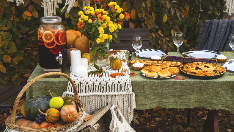 A festive autumn brunch among the yellow trees, with pumpkins, a yellow bouquet and pastries