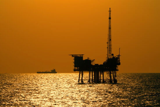 An offshore oil rig photographed at sunset